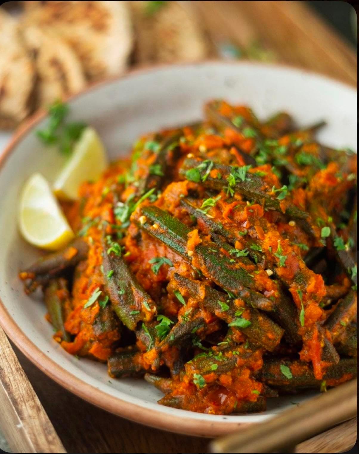 Bhindi Masala — Okra sautéed with onion, tomato and dry-roasted spices until lightly crisp.