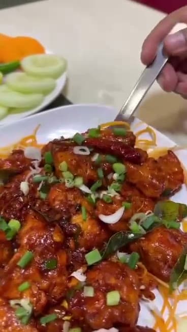 Indo-Chinese chilli chicken tossed with spring onion